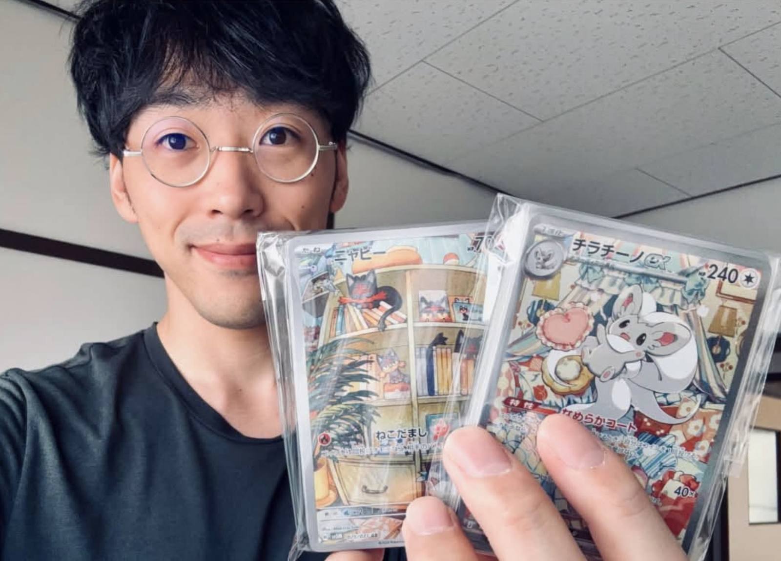 Ryutaro holding Pokémon cards
