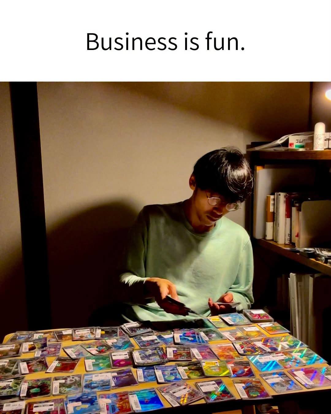 Ryutaro selecting Pokémon cards at his table